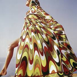 A Model Posing In A Colorful Cover-up by Henry Clarke