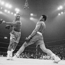 Boxer Ali Dodging A Punch From Frazier by Bettmann