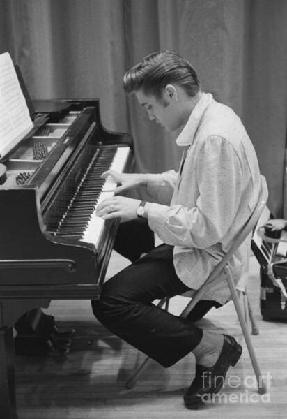 Wall Art - Photograph - Elvis Presley on piano while waiting for a show to start 1956 by The Harrington Collection
